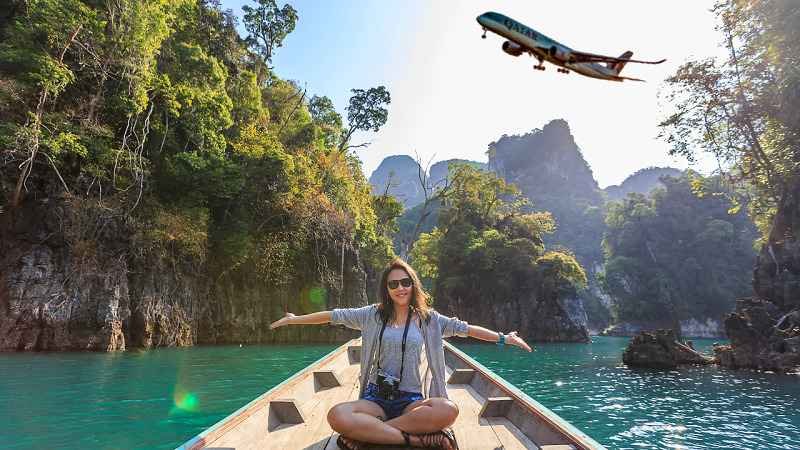“Traveler enjoying a boat ride through tropical waters with an airplane flying overhead promoting discount code ttweakairline”